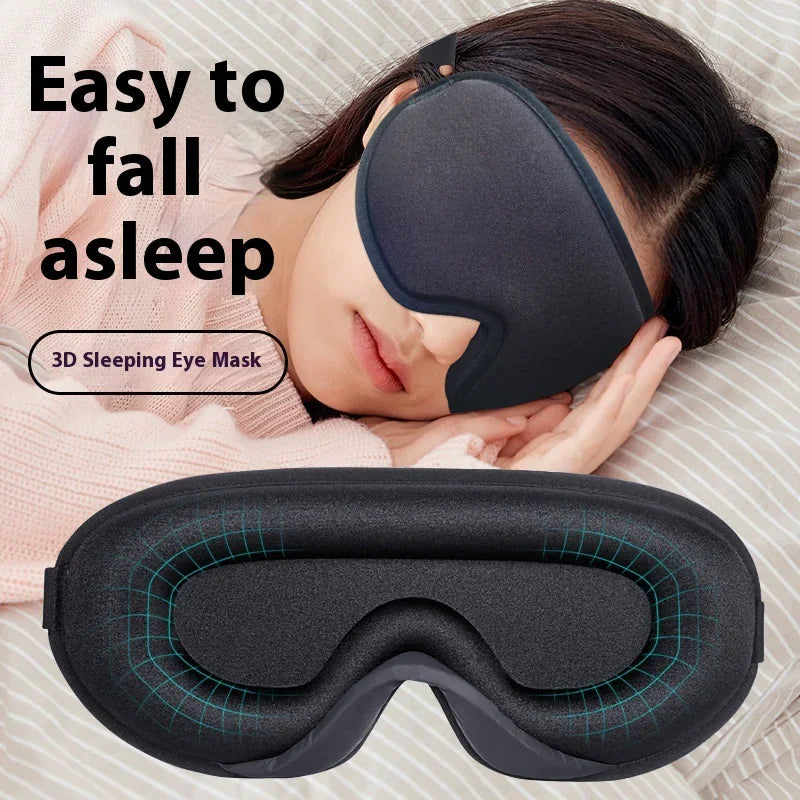 Contoured black sleep mask with 3D eye cavity design resting on folded hands and close-up of inside showing soft cushioning.