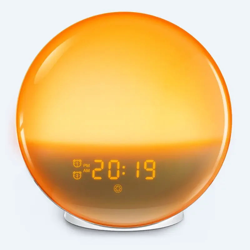 Round sunrise alarm clock with orange circadian light and digital time display on white base.