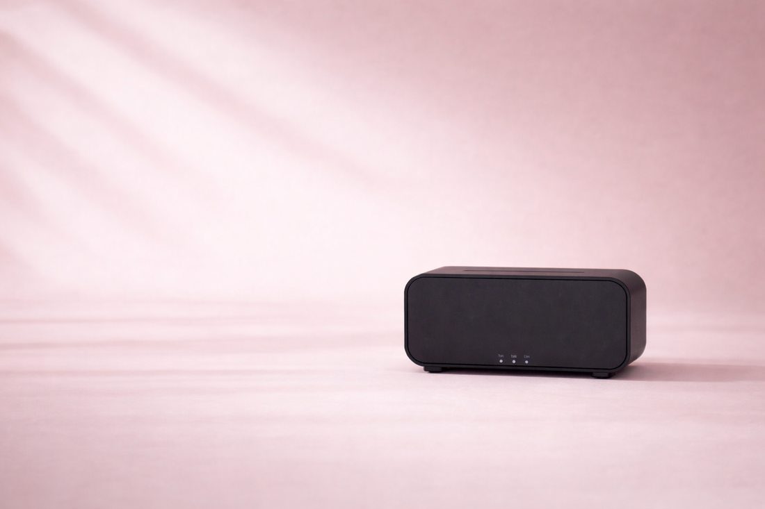 Black rectangular speaker on a pink background