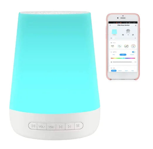 White cylindrical white noise machine with glowing blue light and app interface displayed on smartphone next to it.